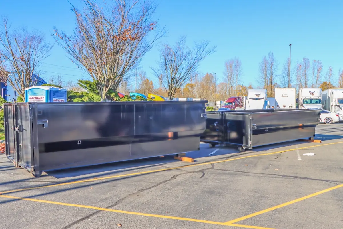 Professional dumpster rental service with roll-off container on residential driveway in Hatboro